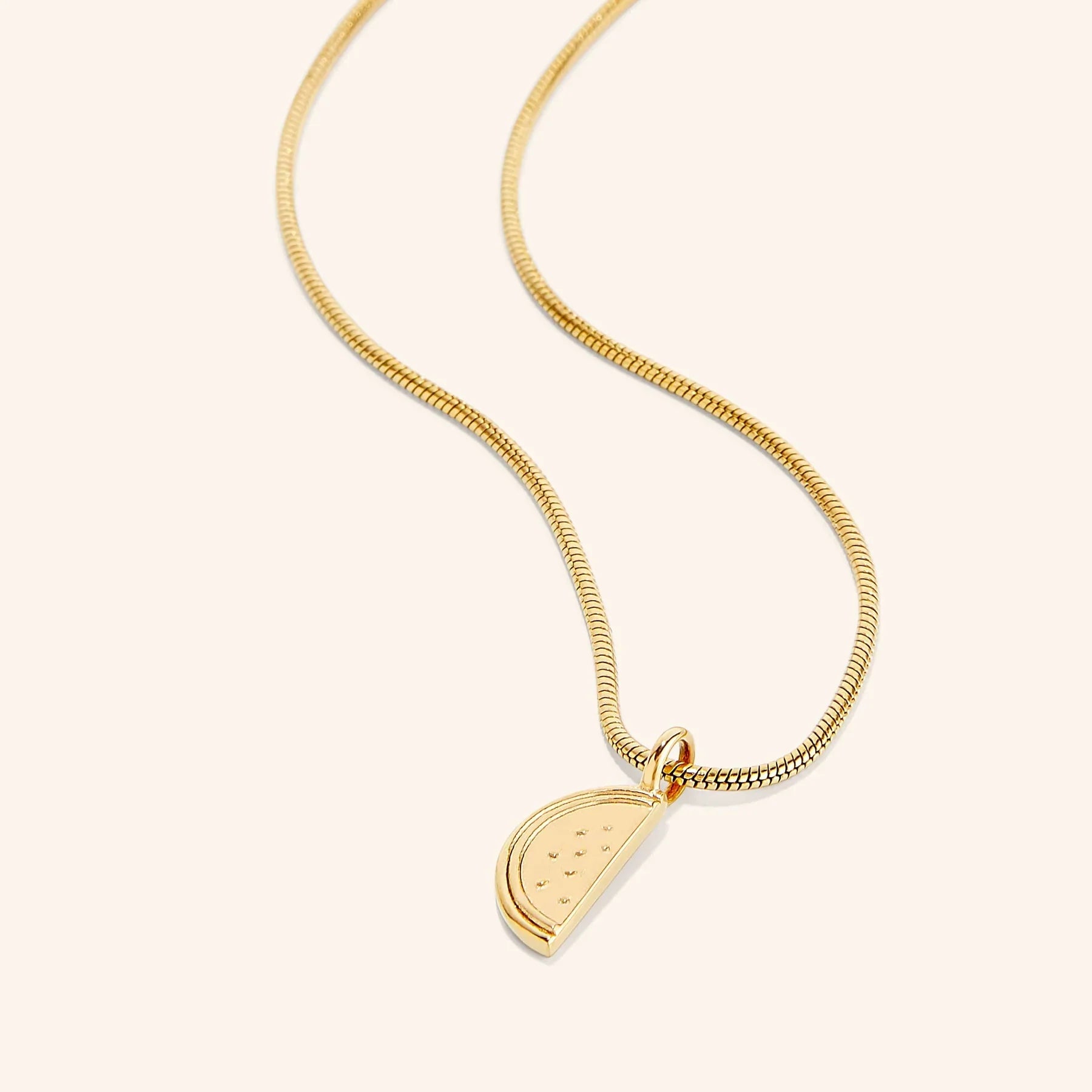 Gold Ayatul kursi necklace with a Palestine melon pendant on a white background