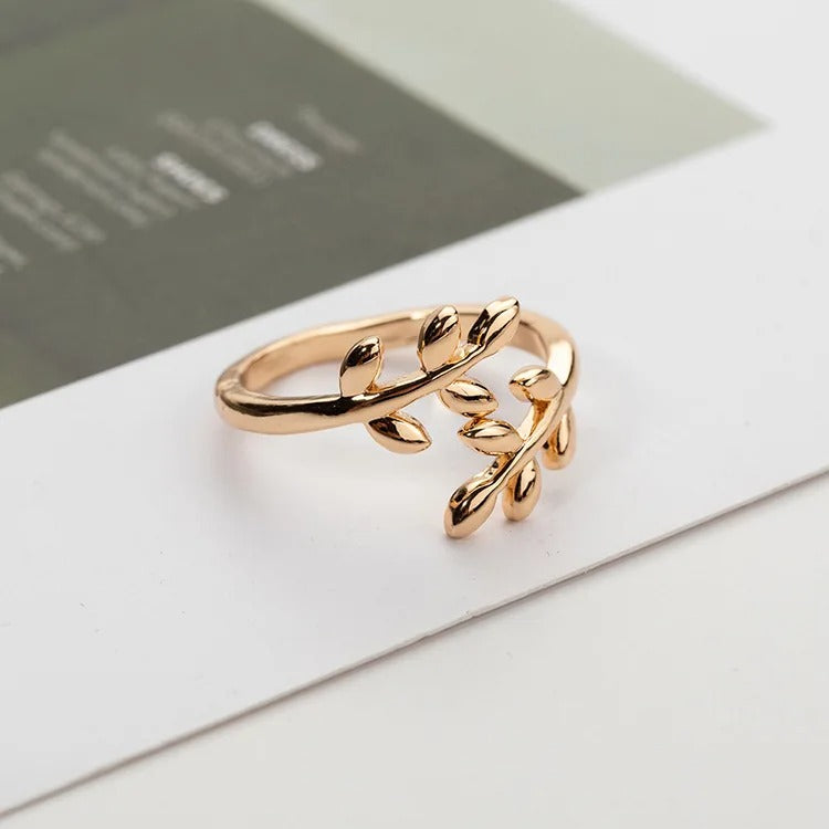 Rose gold palestine leaf-shaped ring on a white surface